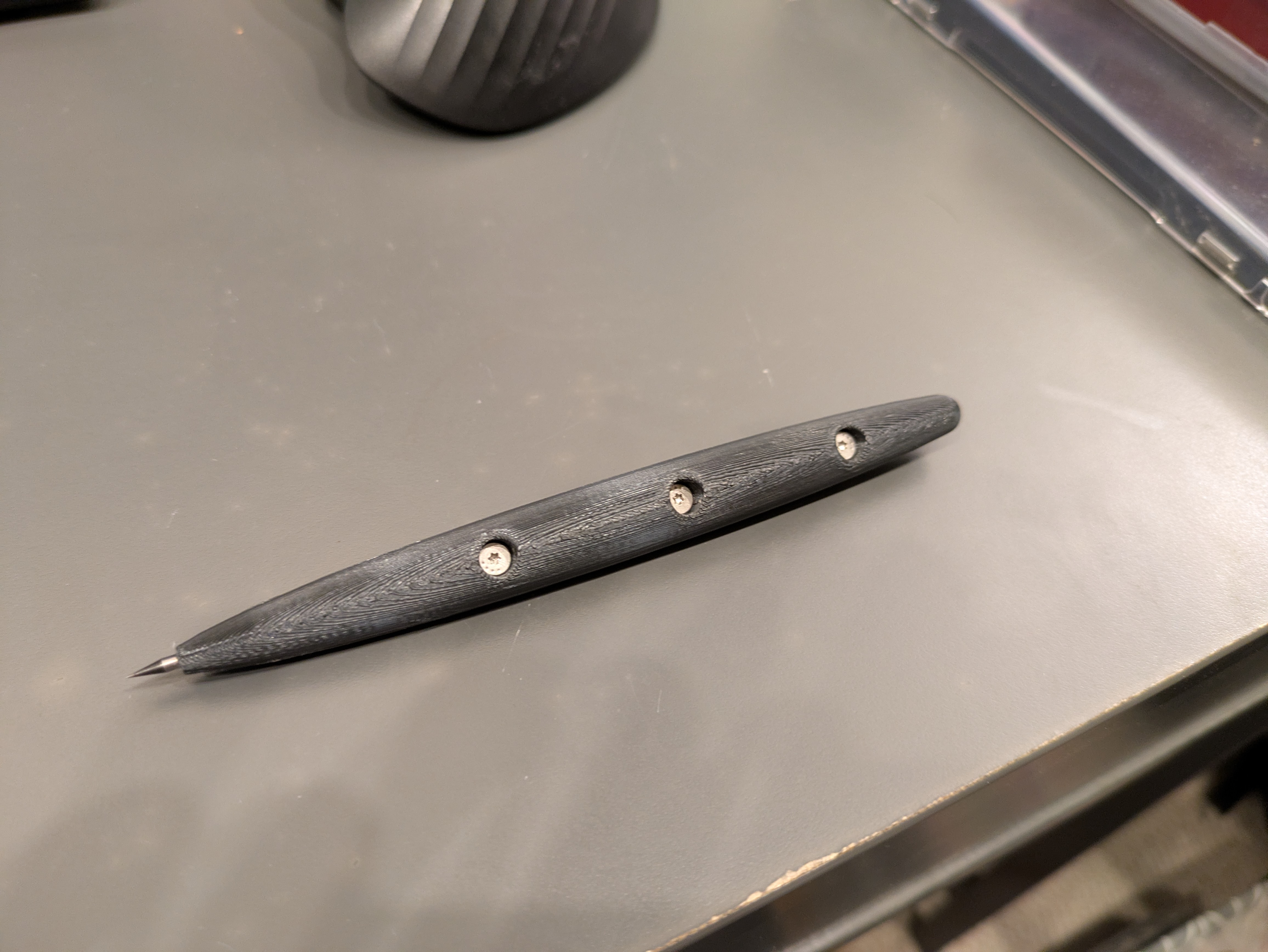 I keep every screw I ever take out of anything I disassemble for exactly this type of project. I just happened to have three of these screws laying around that were perfect for this application.