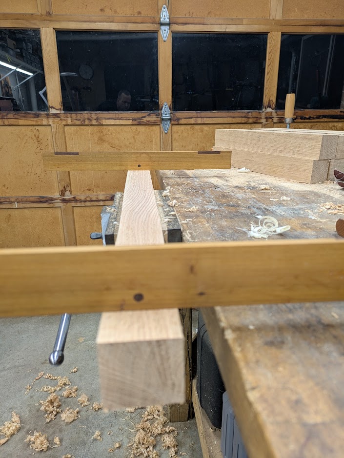 A pair of winding sticks on a board checking for twist.