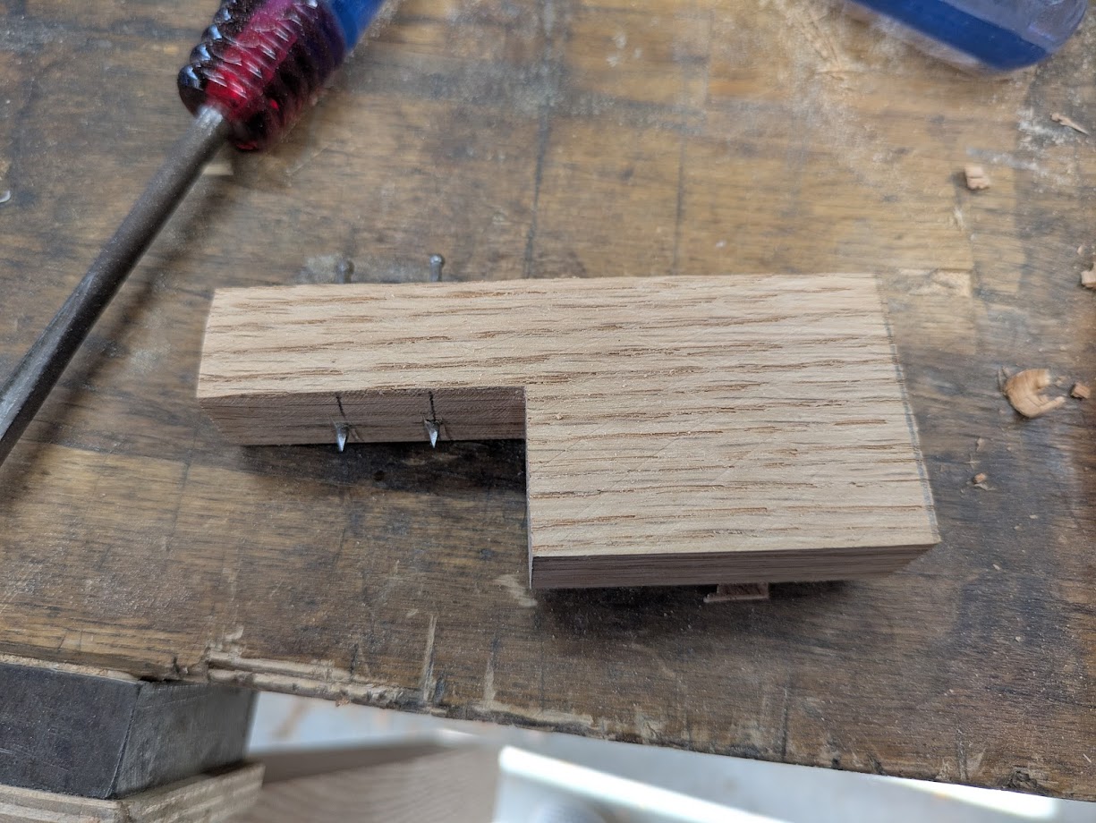 Two nails in a small piece of scrap wood for marking a mortise/tenon.
